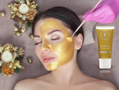 woman applying gold mask
